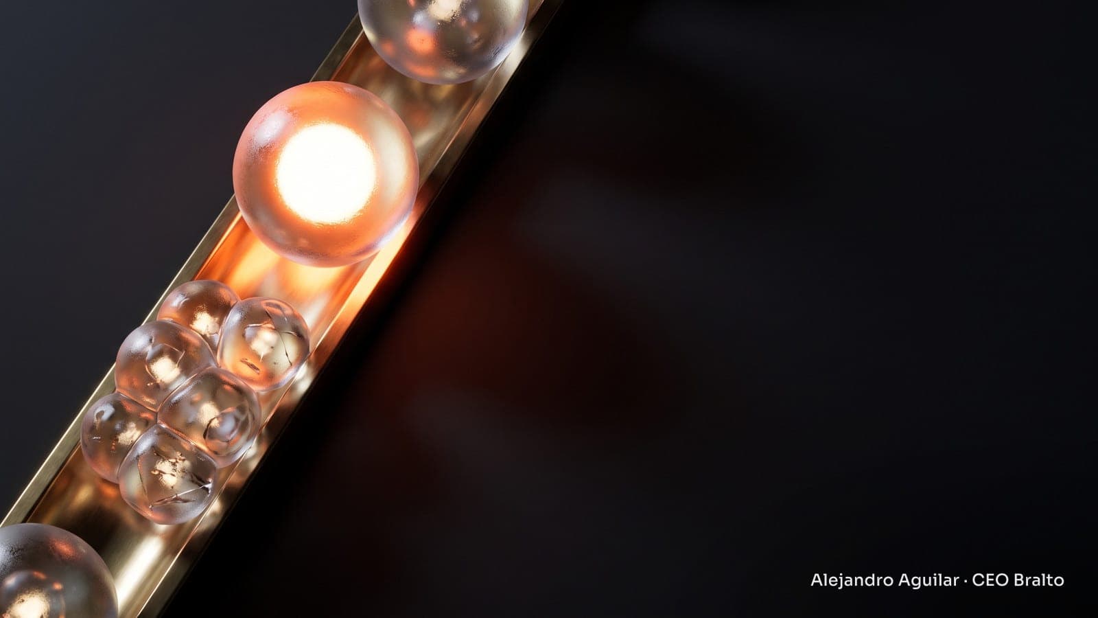 Glass spheres on an illuminated brass track, with a lone core shining more brightly than a cluster of scattered modules.