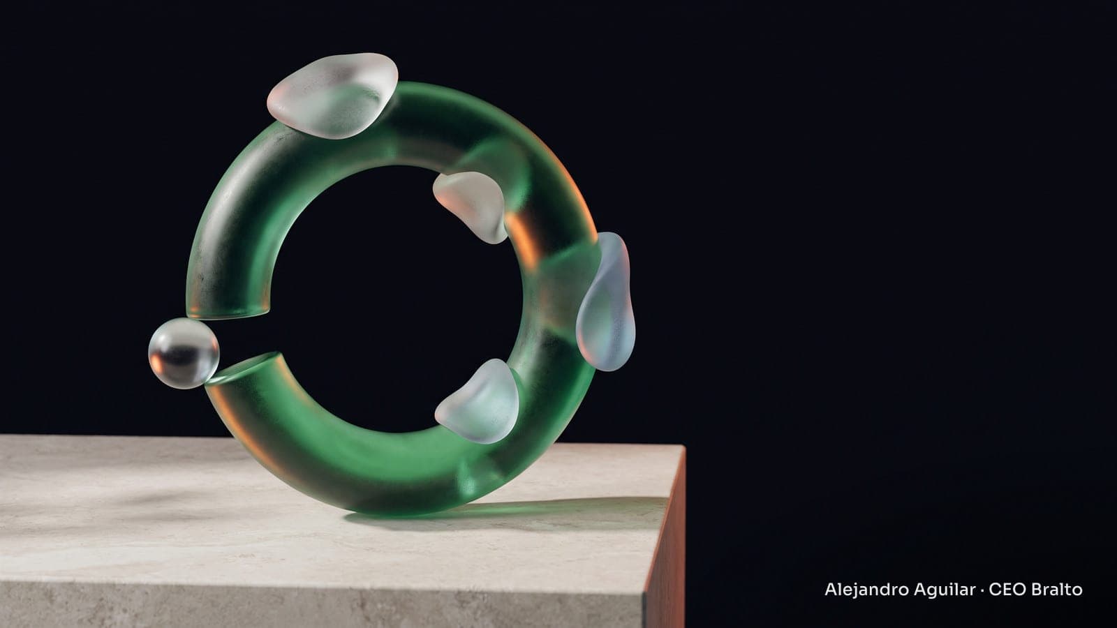 A green glass ring connects several translucent pieces, while a small sphere waits next to an opening.
